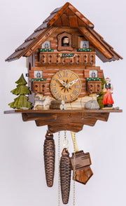 Original 1 Day Cuckoo Clock, Chalet Style, with a handcarved shingle on the roof, trees, a dog and a woman in traditional folk costume with the typical woollen pompoms hat