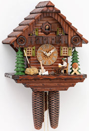 Original 8 Day Cuckoo Clock, typical Black Forest Chalet House, with trees and a traditional dressed Bavarian drinking beer.