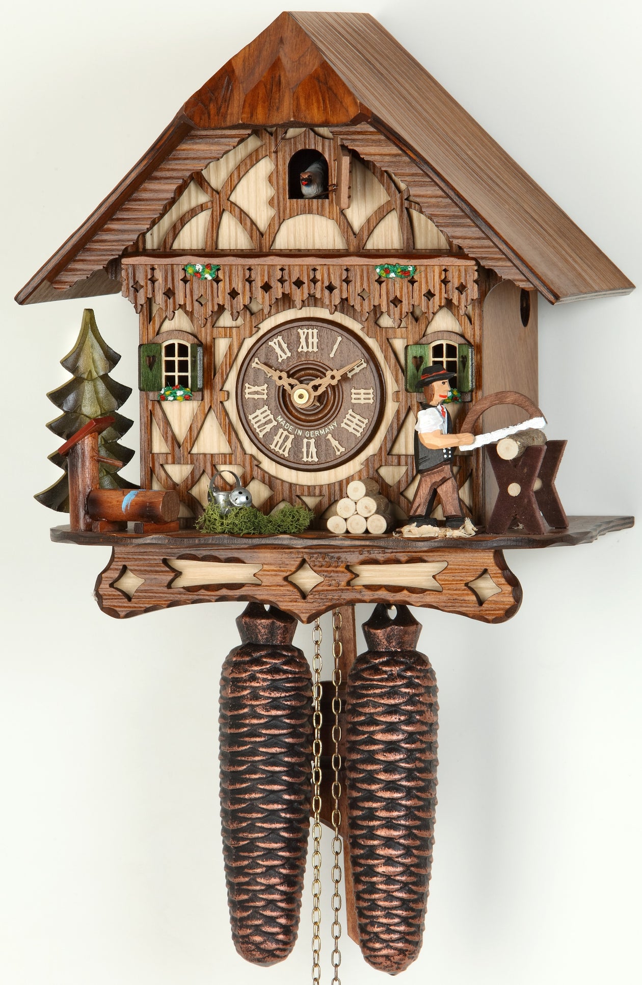 Original 8 Day Cuckoo Clock in a Chalet Style, beautiful scene with a tree, water and a wood cutter sawing wood.
